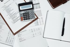A calculator over several documents and a notebook